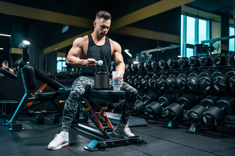 Man preparing supplements before a workout session.