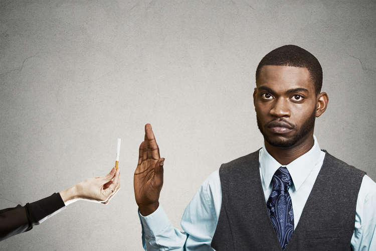 Young business man says no to cigarette offered by person.