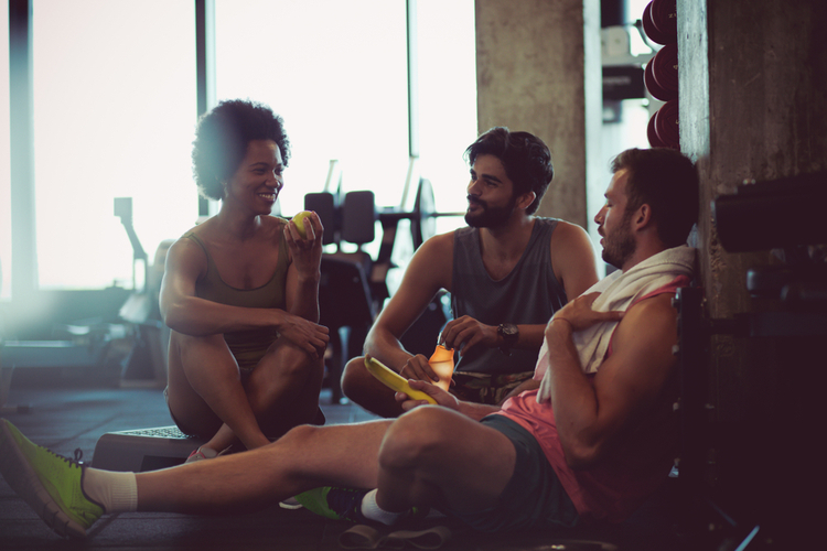 Friends having post-workout meal for muscle recovery.