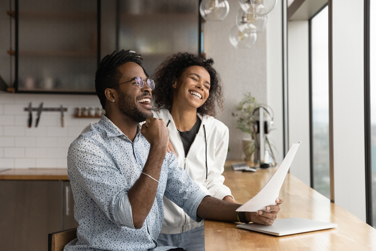 Couple laughing happily after having ideas to make money.