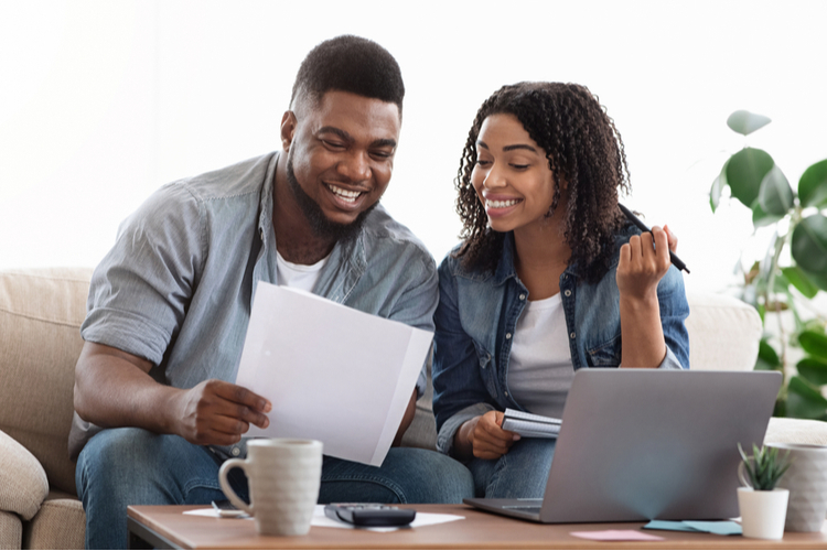 Happy couple doing financial planning.