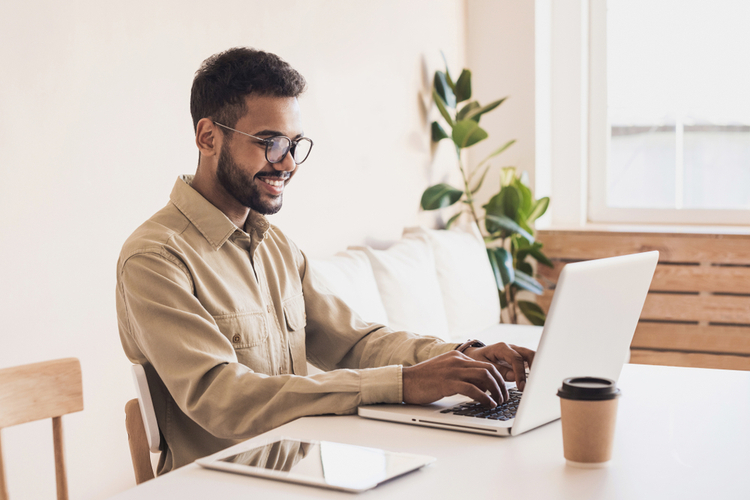 A young man working on his laptop as a freelancer.