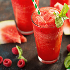 Refreshing cold summer drink watermelon slushie with basil.