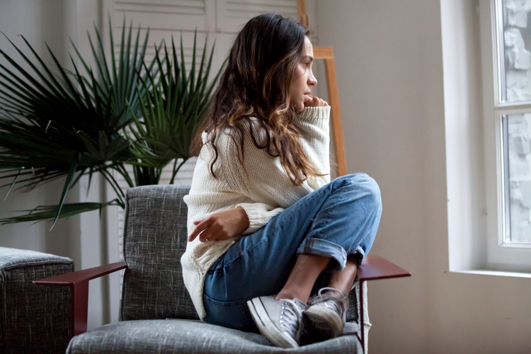 Woman sits on chair feels depressed.
