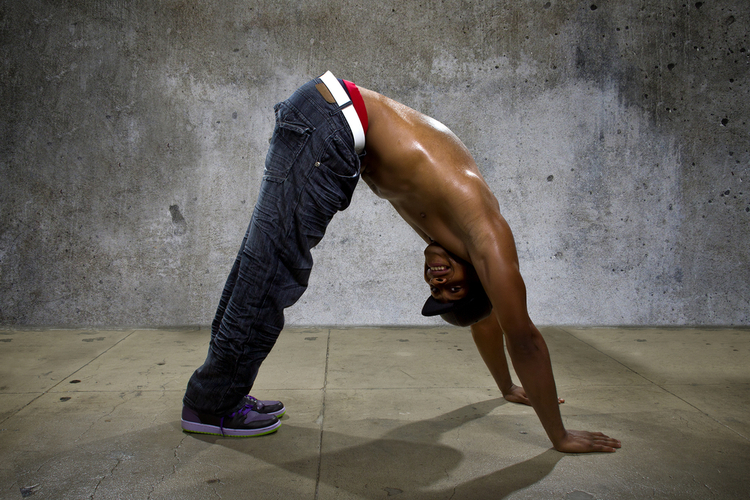 Man demonstrating core balance exercises as one of the yoga poses.