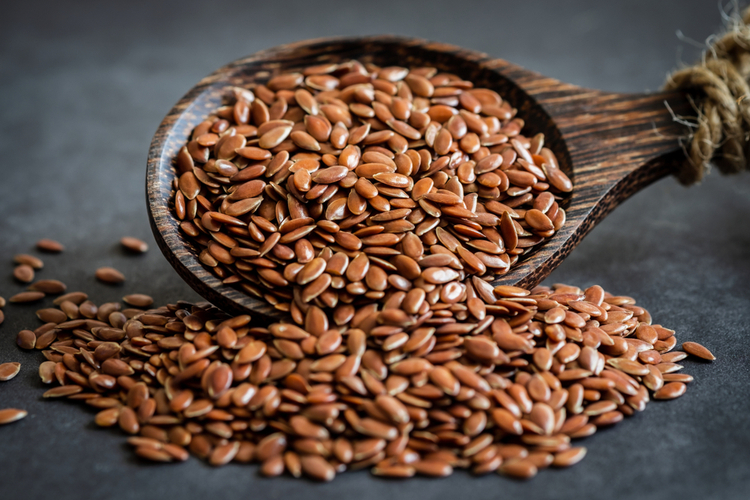 Flax seeds and a wooden spoon.