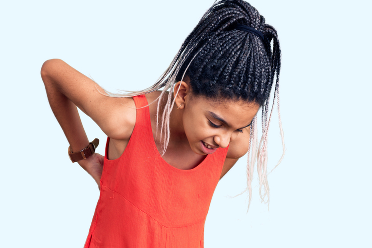 Girl wearing casual clothes suffering of backache.