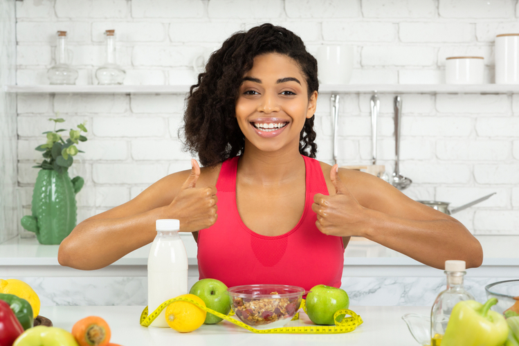 Woman feeling excited to eat with thumbs up.