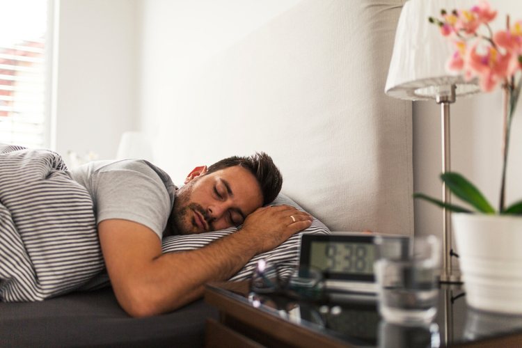 Man sleeping on his bed.