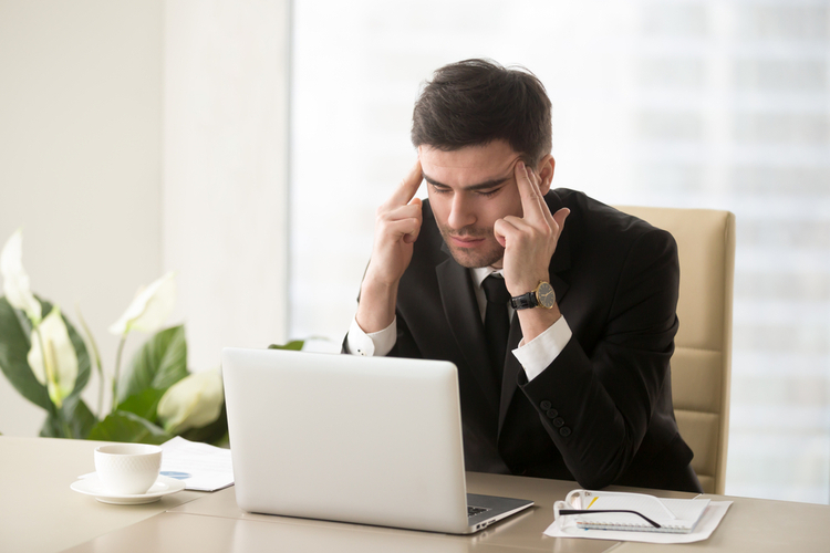 Man feeling stressed at work.