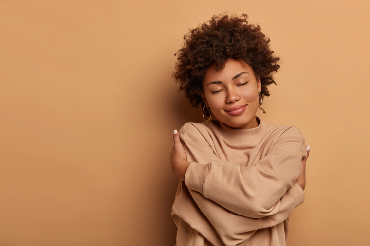 Love Yourself, Self Acceptance. Gentle Lovely Afro American Woman Crosses Hands And Embraces Own Body