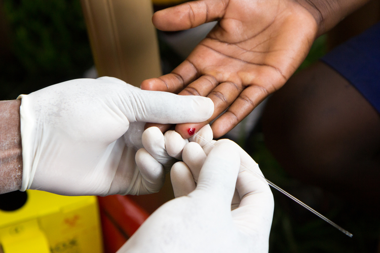 A Health Worker Doing a Finger Prick Test for HIV