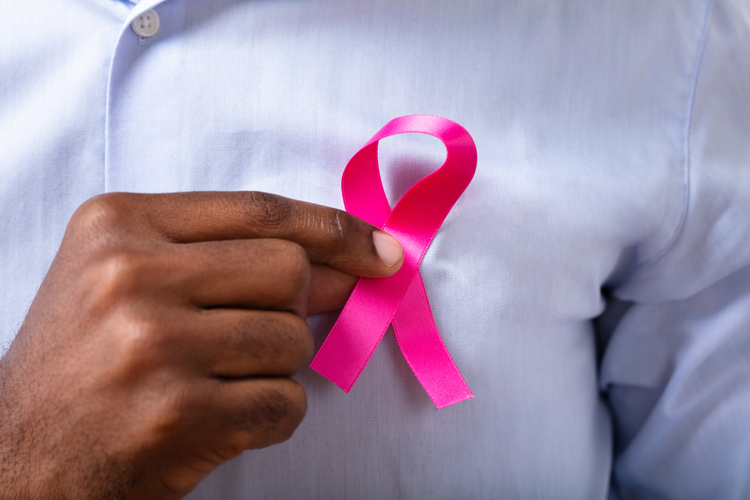 Man's Hand With Pink Ribbon Supporting Breast Cancer Cause