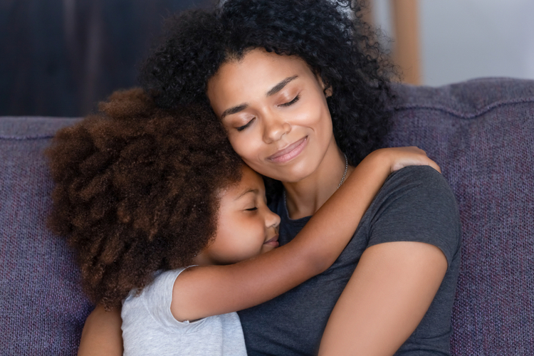 Mom and child hugging each other feeling happiness.