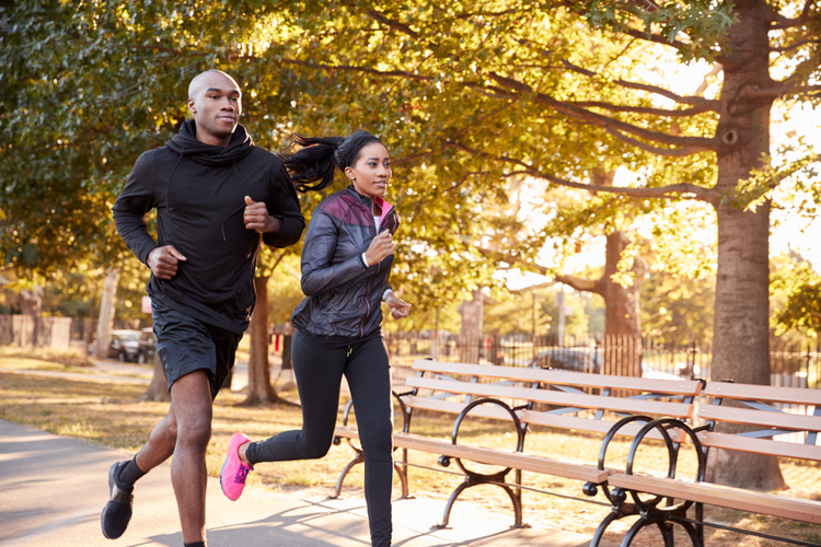 Young fit couple jogging in the park.