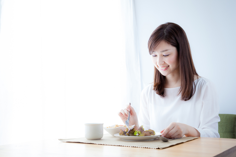 Young Asian woman preparing to eat her meal.