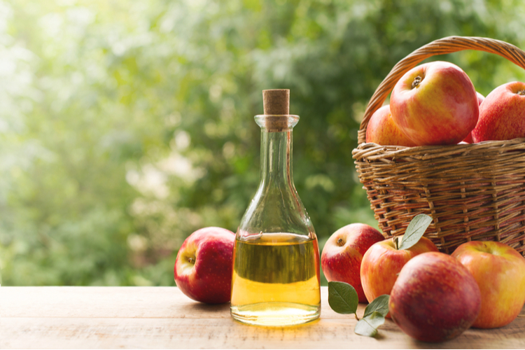 Apple cider vinegar in bottle with apples as source of now foods apple cider vinegar tablets.