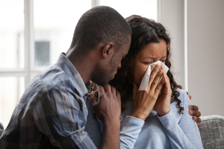 African American couple grieving.