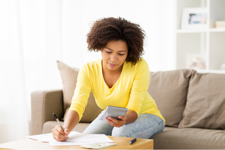 50 30 20 rule budget, Finances And People Concept - Woman With Papers And Calculator Counting Money At Home