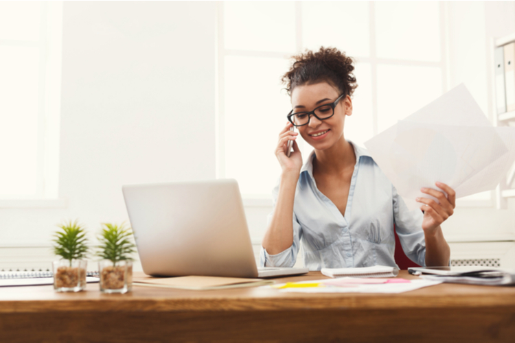 Woman Is talking with her client and at the same time trying how to stay productive.