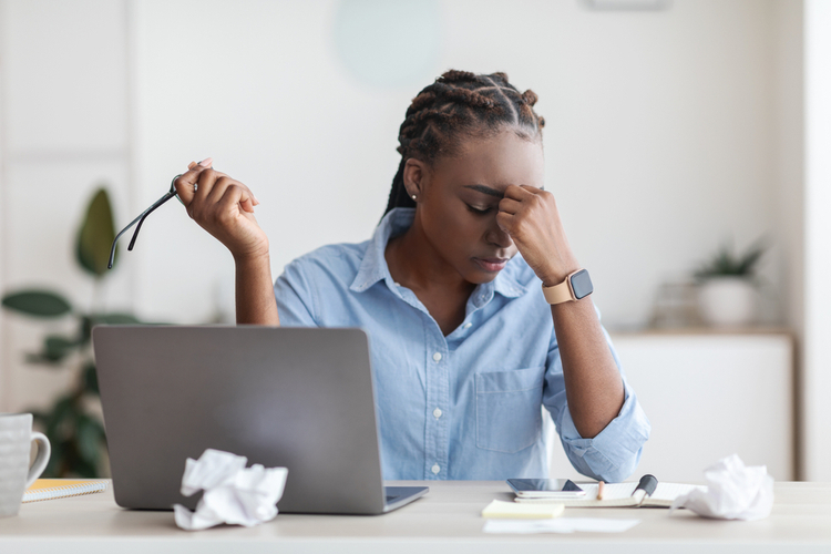 building resilience: overworked Black Female Entrepreneur Massaging Nosebridge At Workplace In Office