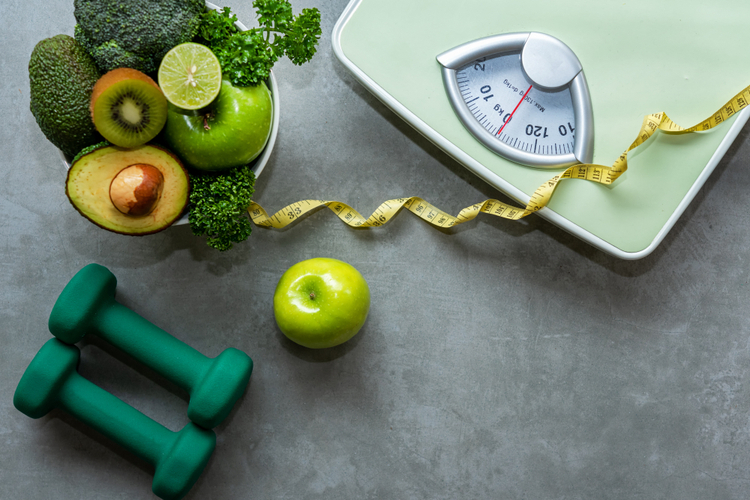Organic Green apple and weight scale measure tap with nutrition vegan vegetable and sport equipment gym perfect for world diabetes day.
