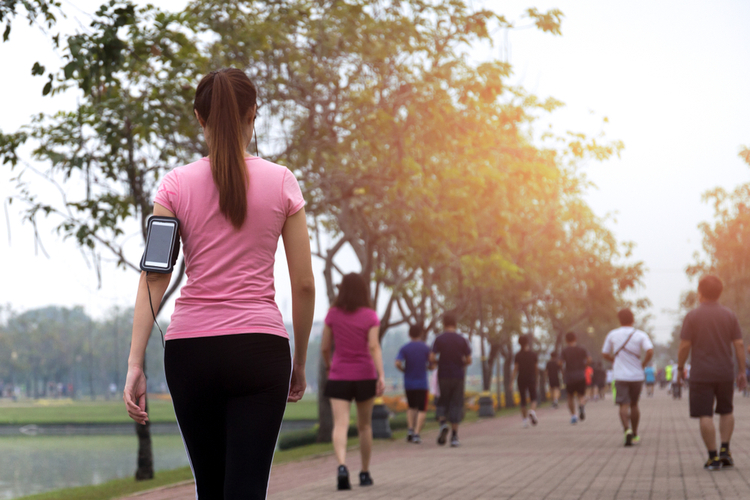Group of people exercise power walking in the park in morning