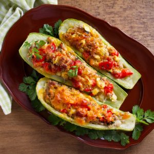 Zucchini stuffed with meat, vegetables and cheese.