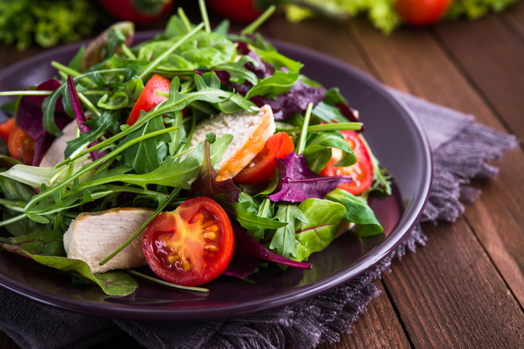 Fresh salad with chicken, tomatoes and mixed greens
