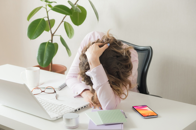 Tired woman laid her head down on the table.