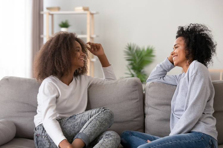 mother and teen daughter having pleasant conversation,