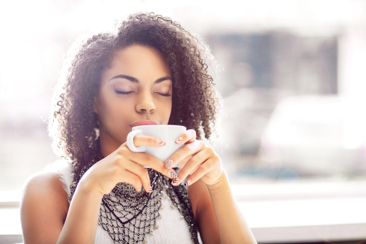 Pleasant girl drinking coffee