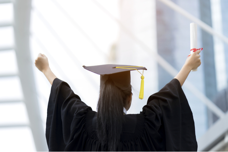 Woman Wearing Graduation Dress and Cap, Holding Her Graduation's Diploma