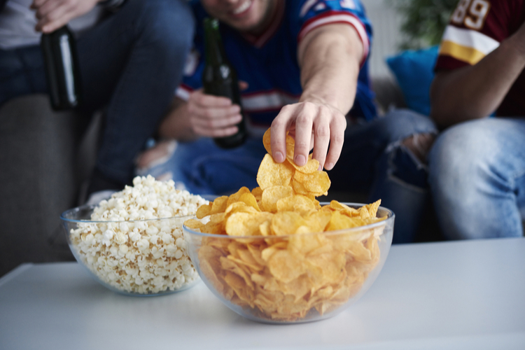 Close up of men's hand grabbing chips
