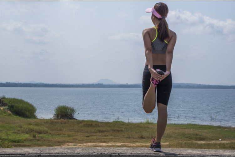 woman runner resting after workout session on sunny morning.