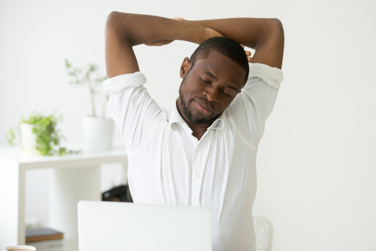 man stretching doing easy office exercises to relieve muscle tension