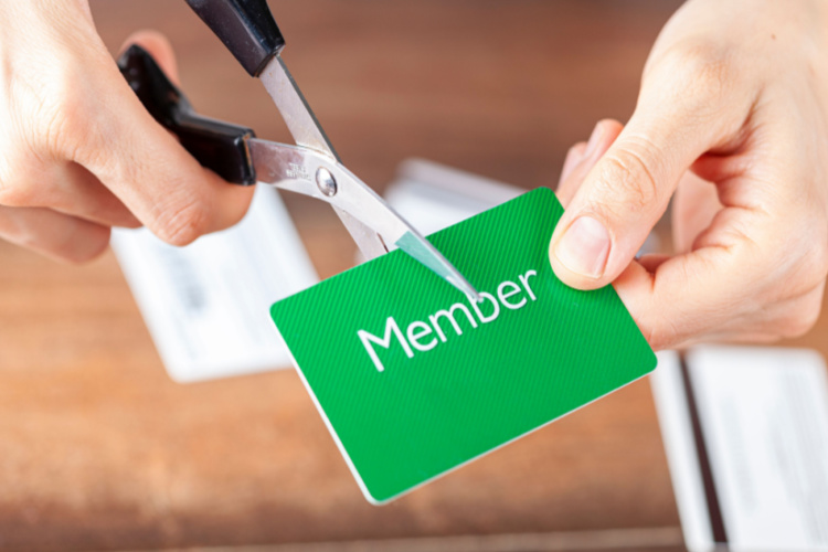 woman cutting a membership card.