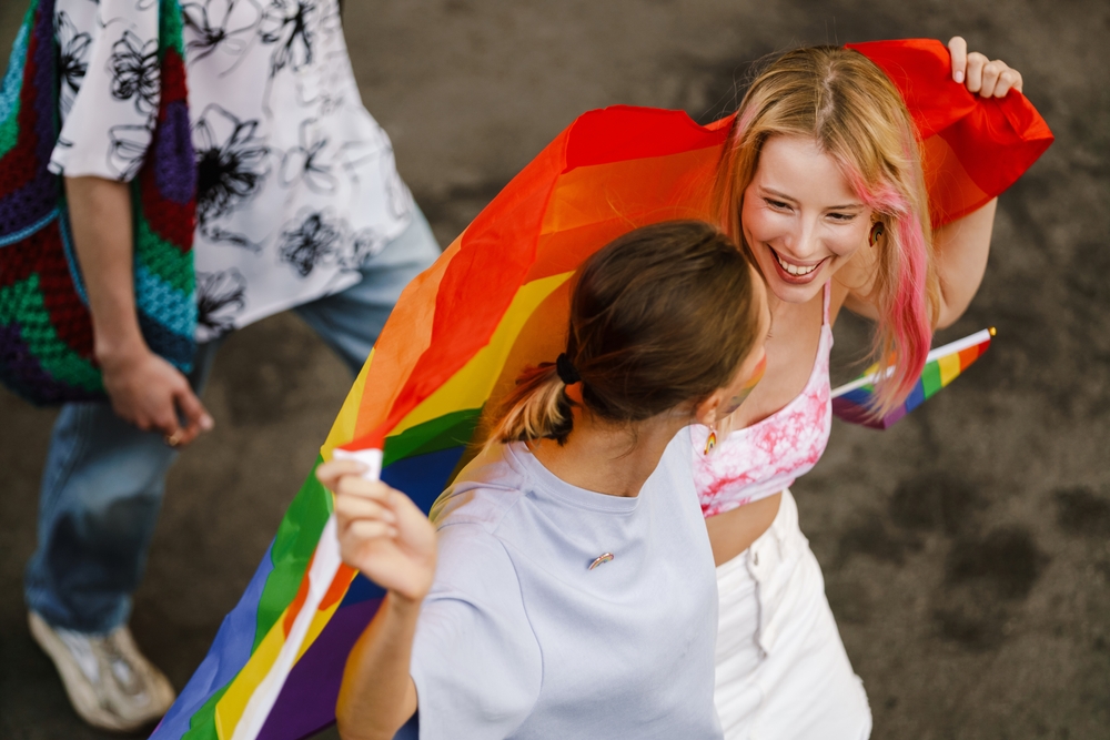 People Holding a Flag in Celebration of Pride