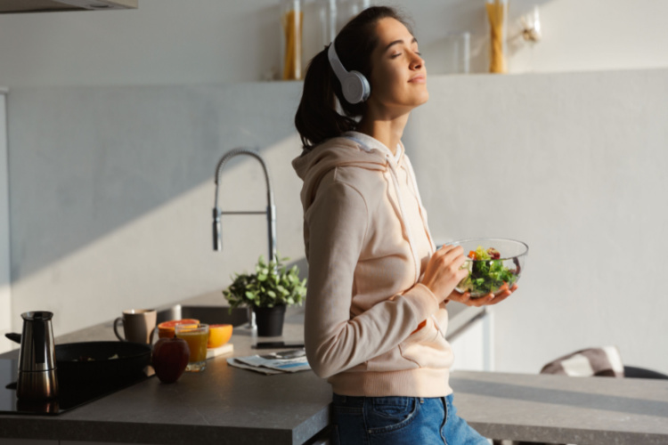happy healthy woman in the kitchen standing daily morning routine