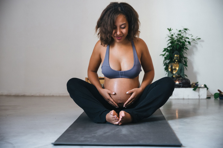 Pregnant doing meditation exercises at a yoga class