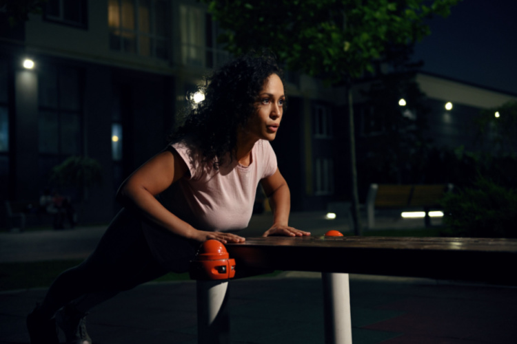 performing push-ups from a wooden bench