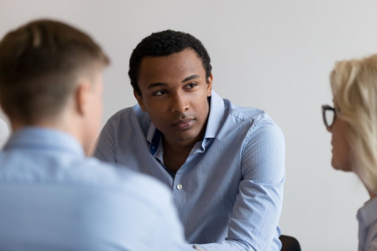 Businessman concentrated on listening at group meeting