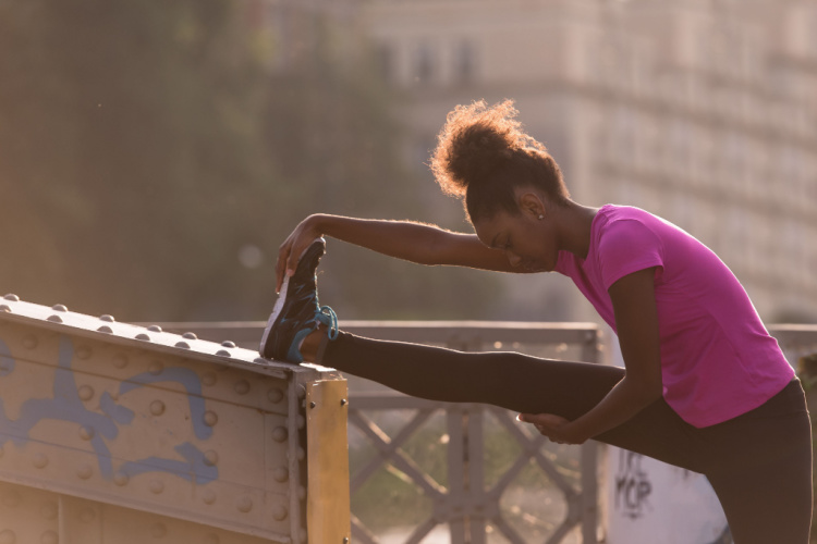 doing warming up and stretching with her leg raised to the bridge