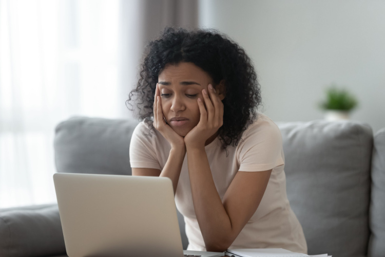 Girl tired of learning sit at home looking at laptop