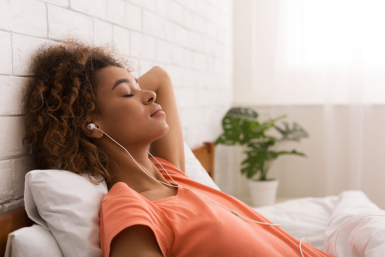 Woman relaxing and listening to music to relieve anxiety