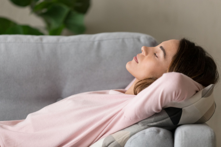 woman lying on comfy couch