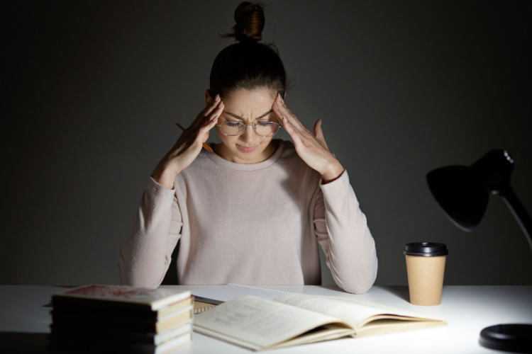 stressful woman keeps hands on head